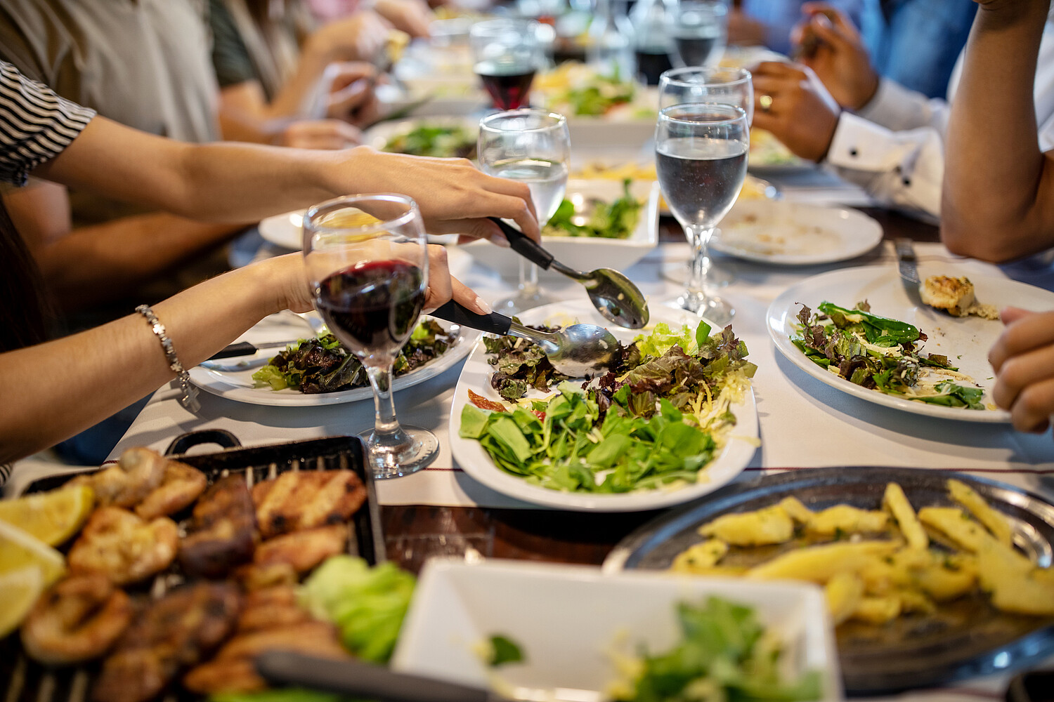 Food and wine on the restaurant table for family lunch Food and wine on the restaurant table for family lunch