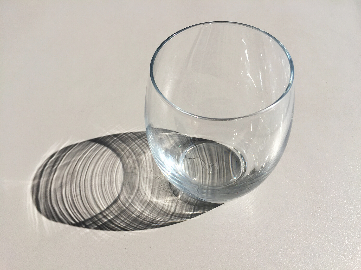 Empty glass with reflection on table surface Empty glass with reflection on table surface